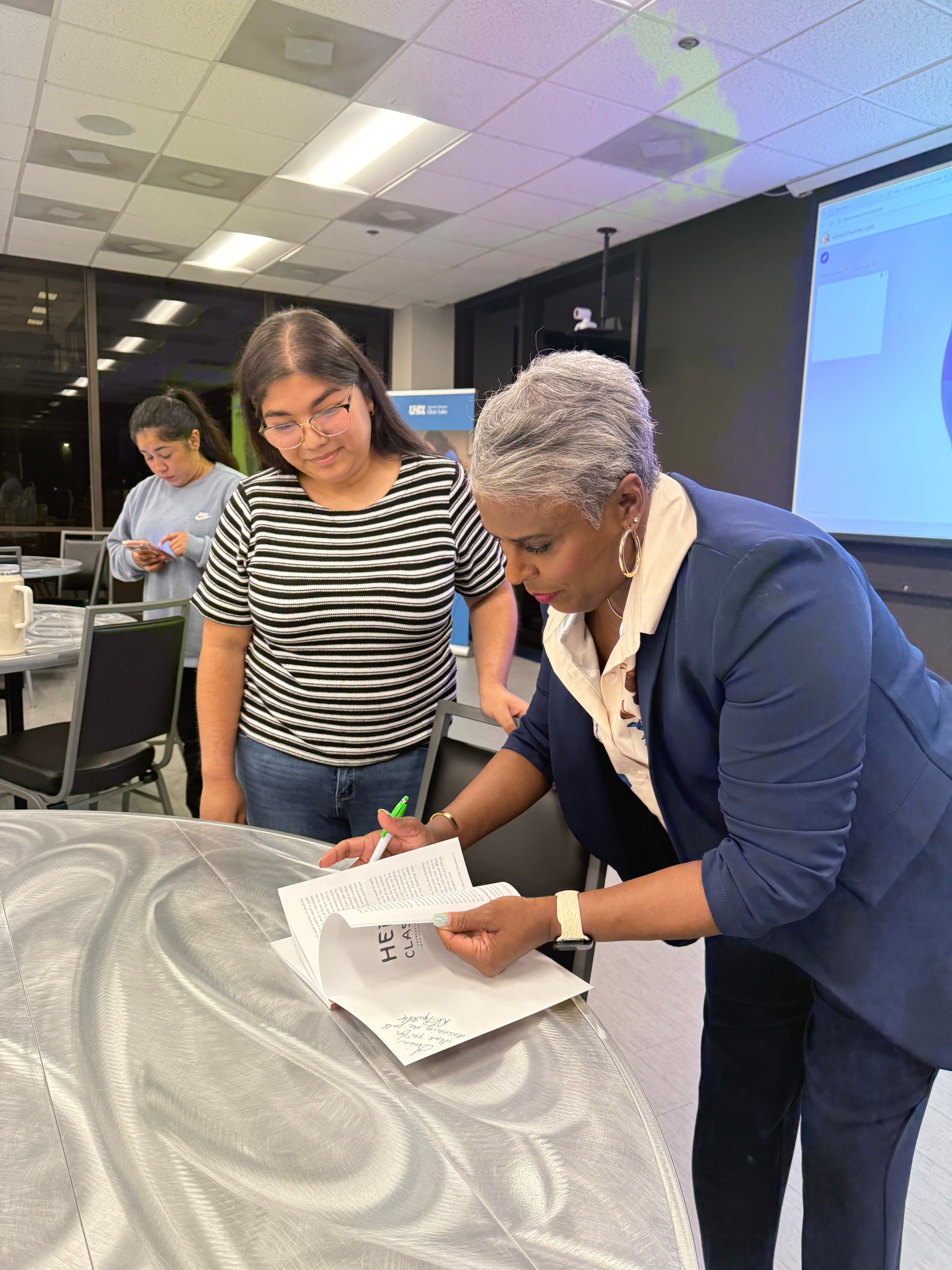 Dr. Rachel Alex reviewing materials with a colleague at a HELP in Schools session